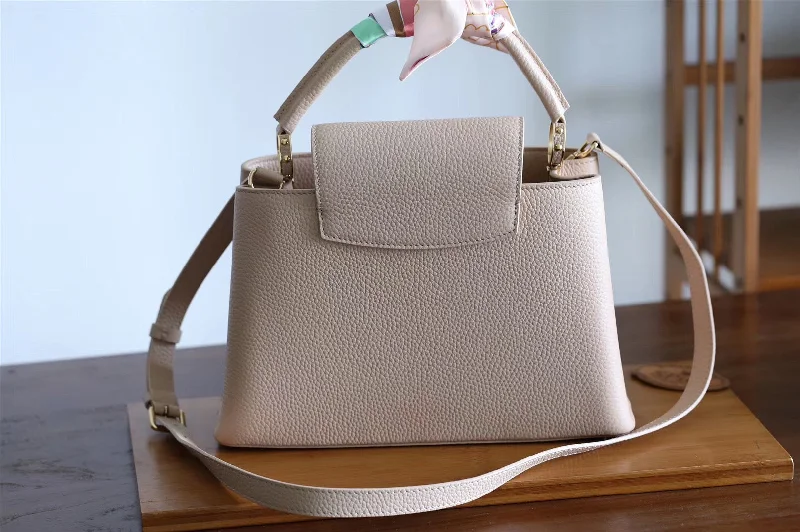 Ladies Louis Vuitton Petite Malle bags in a pastel color for a soft lookLouis Vuitton Capucines MM Bag